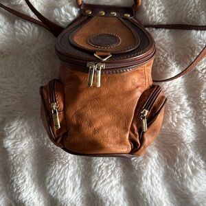 Vintage Valentino Leather Backpack with Gold Accents and convertible straps.